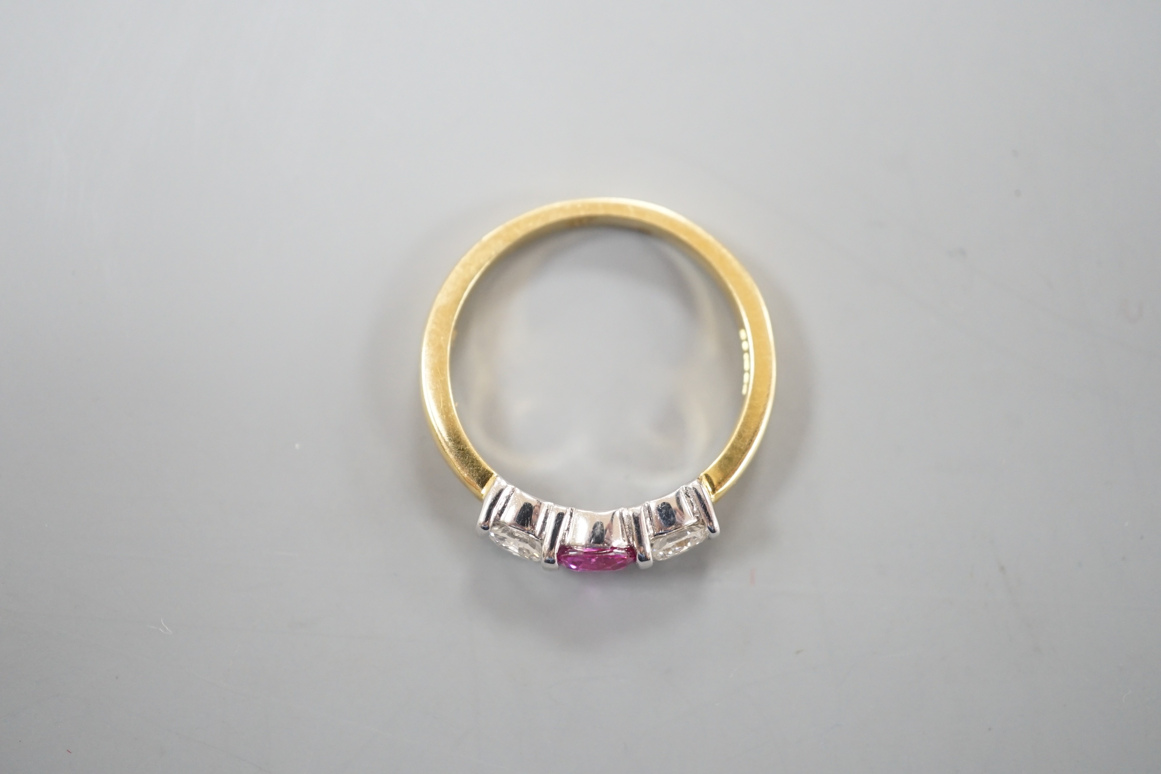 A modern 18ct white gold pink sapphire and diamond set three stone ring, size M, gross weight 4 grams